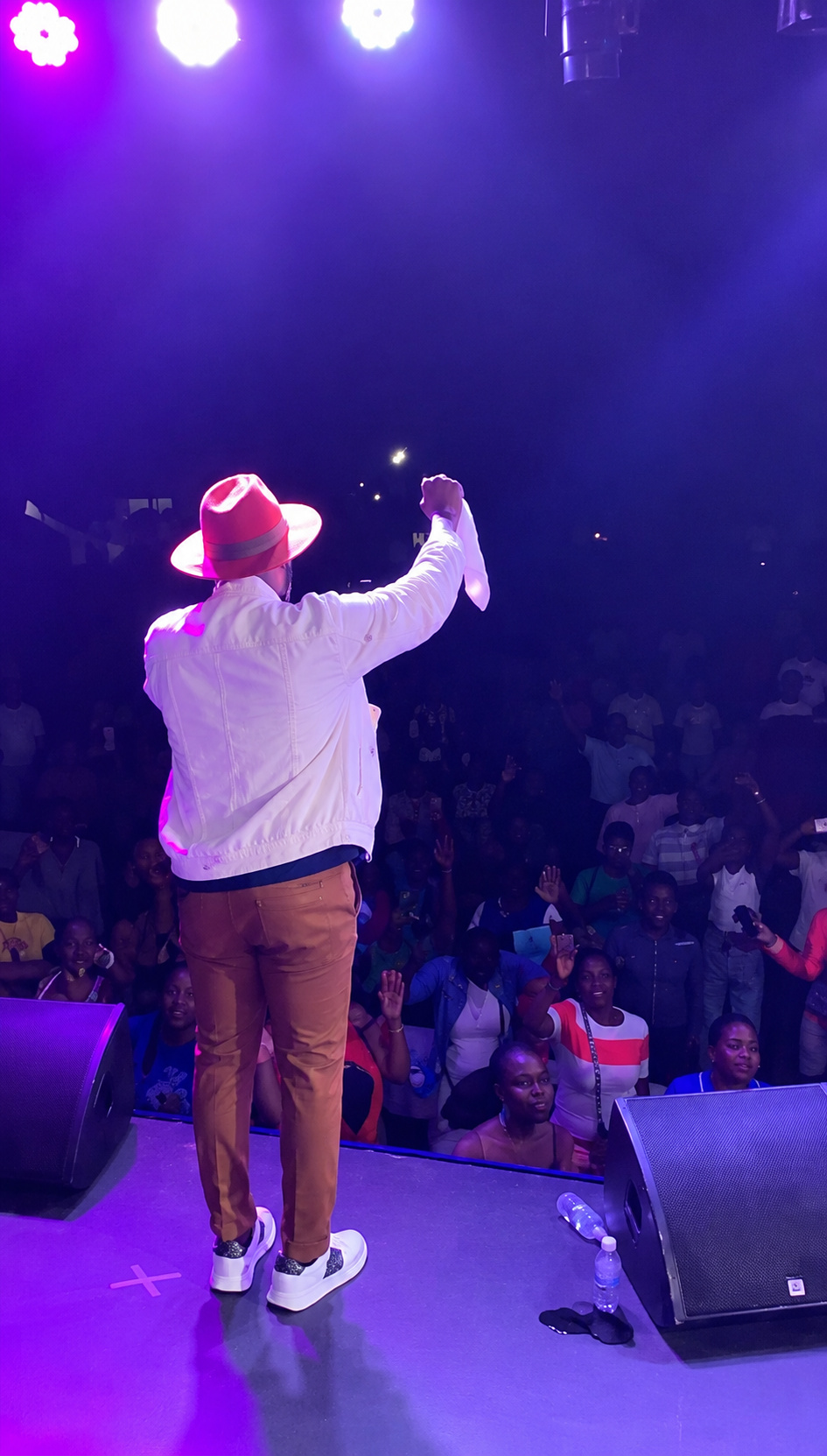 Kevin Downswell on stage, arm raised, ministering to the congregation